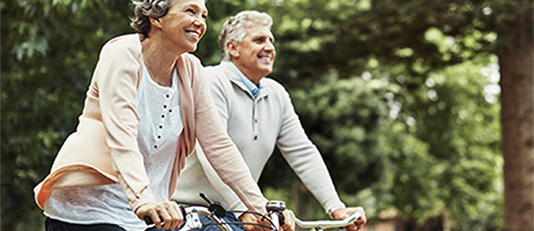 Man and woman enjoying riding their bikes outside